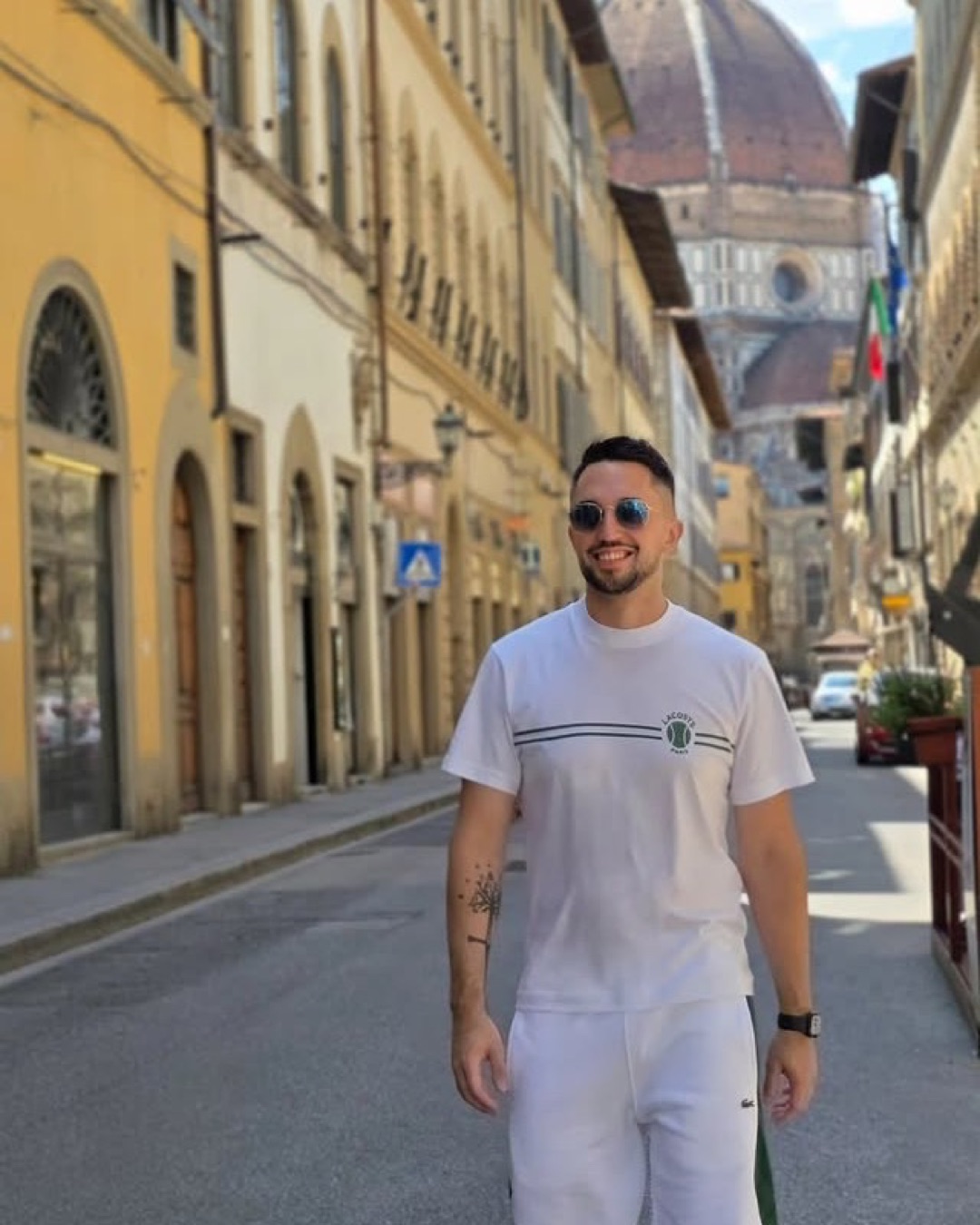 Aday González walking through Florence with the Duomo in the background
